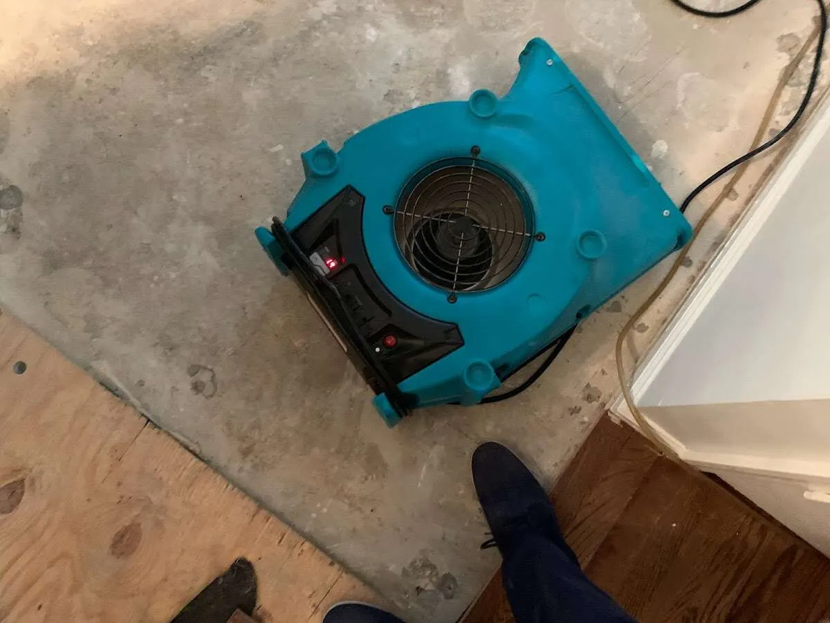 Air mover drying subfloor during Commercial Water Damage Restoration in Kings Mountain